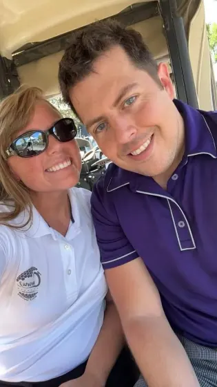 Colin and Taylor smiling at the golf outing