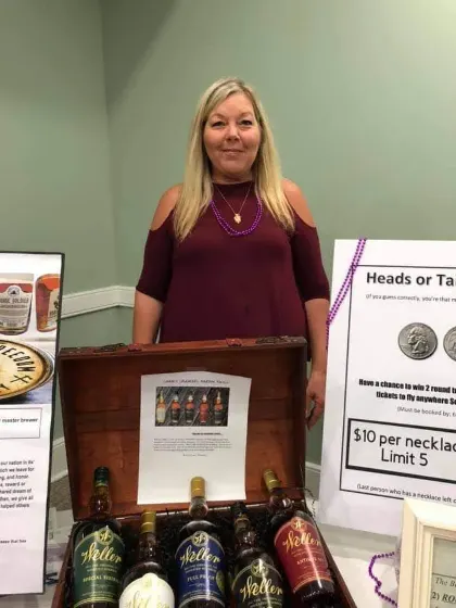 Tracy at Sip & Swirl beside the Weller raffle display