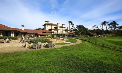 Resort buildings above a golf course on a sunny day