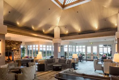 Resort lounge with a fireplace and tall windows