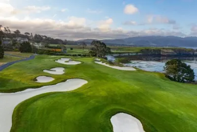 Aerial view of a golf hole with bunkers beside the coast