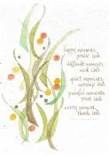 Green and orange painted sprigs beside short lines of calligraphy on white paper